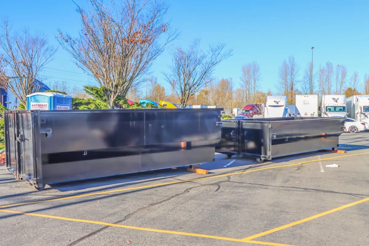 Professional dumpster rental service with roll-off container on residential driveway in Rosendale